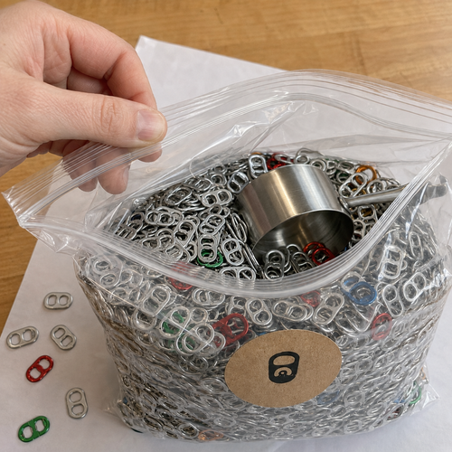 Collected aluminum pop tabs stored in a clear resealable bag